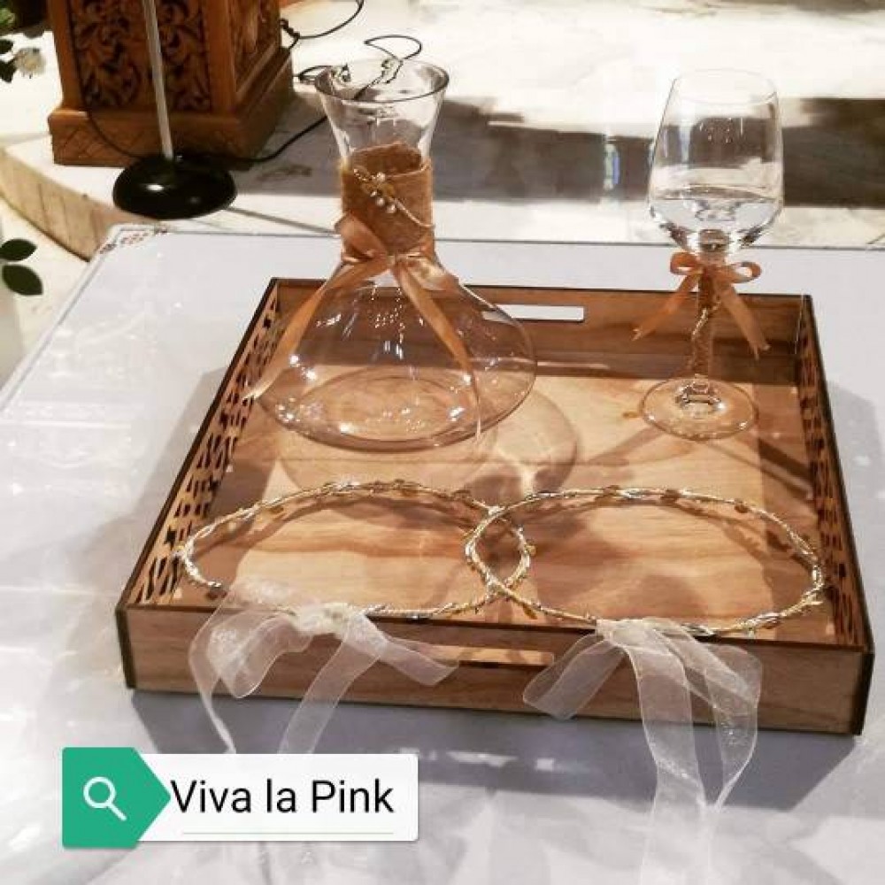 glass bottle glass with brown ribbon wooden tray
